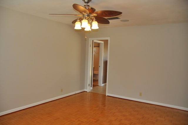 empty room featuring ceiling fan and light parquet flooring