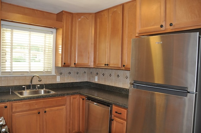 kitchen with decorative backsplash, sink, and stainless steel appliances