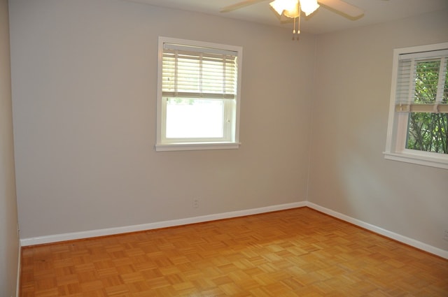 empty room featuring ceiling fan and light parquet flooring