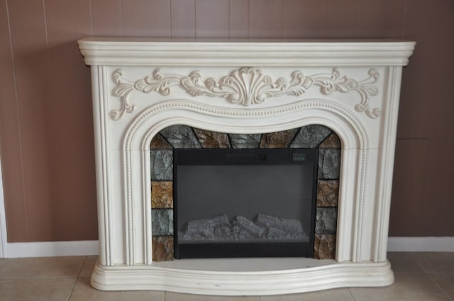 interior details featuring a tiled fireplace