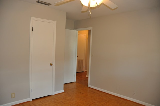 unfurnished bedroom featuring ceiling fan and light parquet flooring