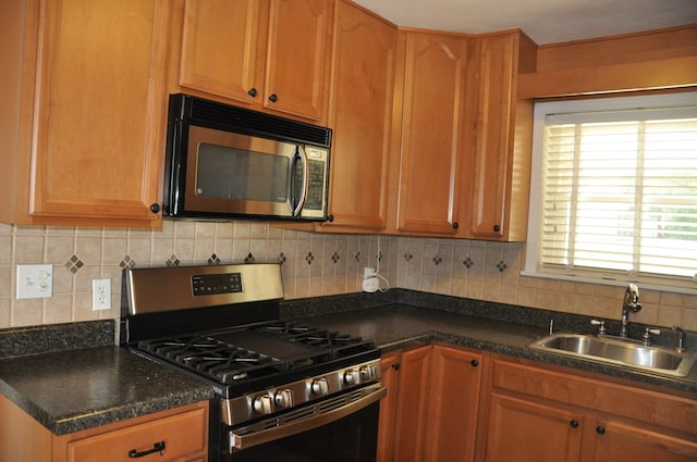 kitchen featuring decorative backsplash, sink, and stainless steel appliances