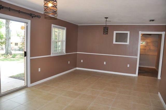 spare room with light tile patterned floors and ornamental molding