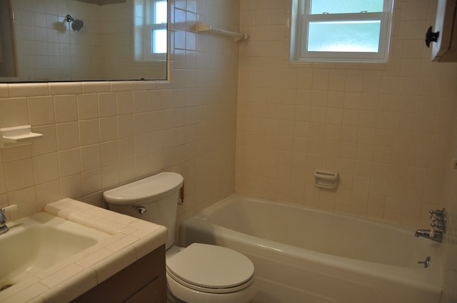 full bathroom featuring plenty of natural light, toilet, and tile walls