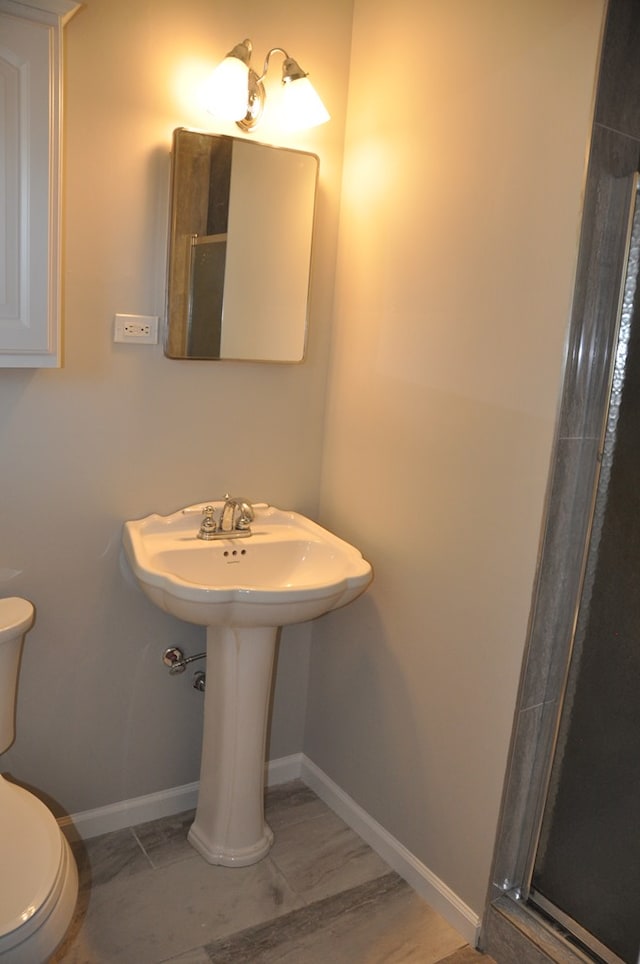 bathroom featuring an enclosed shower and toilet