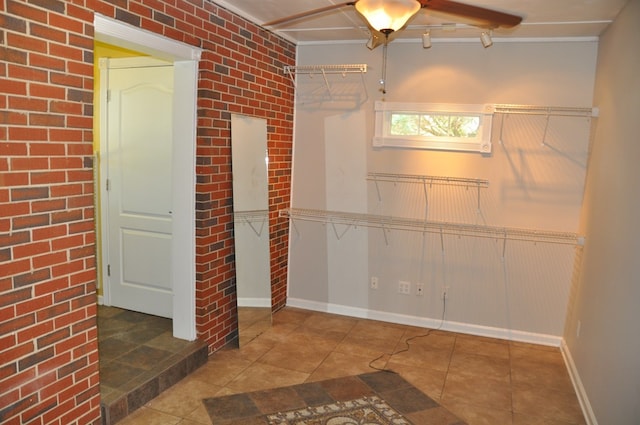 basement with tile patterned flooring and brick wall