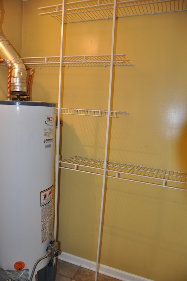 utility room featuring water heater