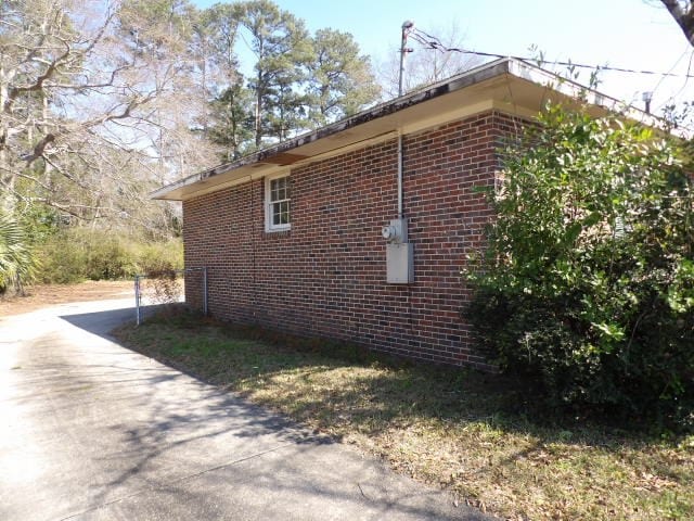 view of home's exterior with brick siding