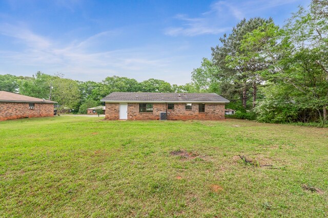 212 Johanna Dr, Ozark, AL 36360 - back of property with a lawn and brick siding