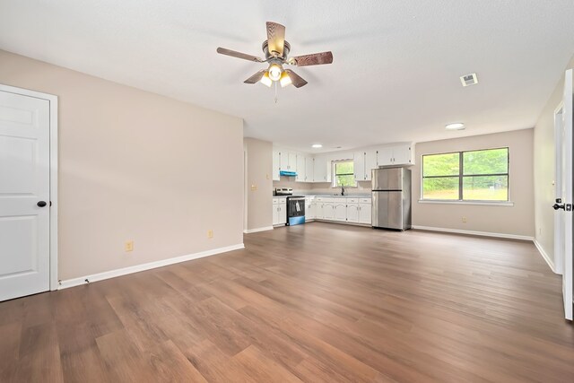 212 Johanna Dr, Ozark, AL 36360 - unfurnished living room with wood finished floors and a ceiling fan