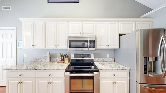 119 Willow Oaks Dr, Headland, AL 36345 - kitchen with stainless steel appliances, white cabinets, and visible vents