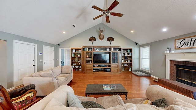 119 Willow Oaks Dr, Headland, AL 36345 - living room with ceiling fan, wood finished floors, a brick fireplace, and recessed lighting