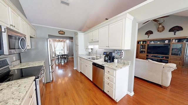 119 Willow Oaks Dr, Headland, AL 36345 - kitchen with white cabinets, stainless steel appliances, lofted ceiling, and visible vents