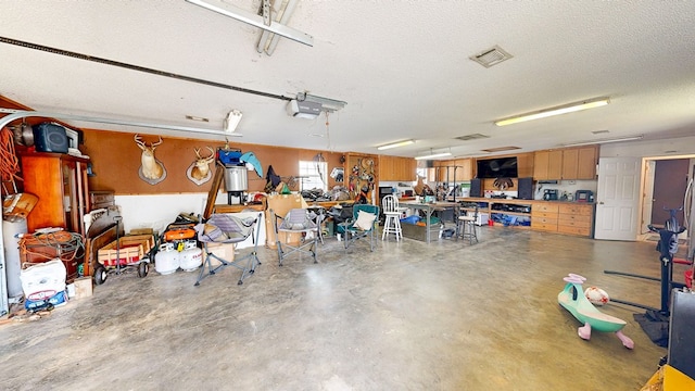 119 Willow Oaks Dr, Headland, AL 36345 - garage featuring visible vents and a garage door opener