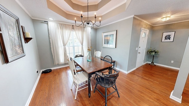 119 Willow Oaks Dr, Headland, AL 36345 - dining room featuring light wood finished floors, baseboards, ornamental molding, and a notable chandelier