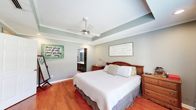 119 Willow Oaks Dr, Headland, AL 36345 - bedroom featuring crown molding, a raised ceiling, visible vents, and light wood-style floors
