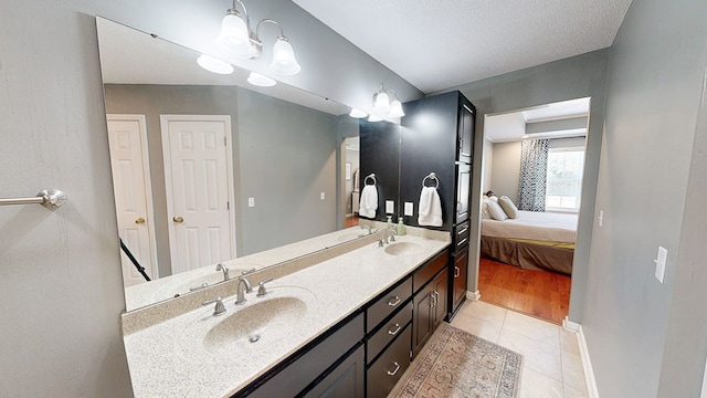 119 Willow Oaks Dr, Headland, AL 36345 - ensuite bathroom with a sink, tile patterned flooring, double vanity, and ensuite bath