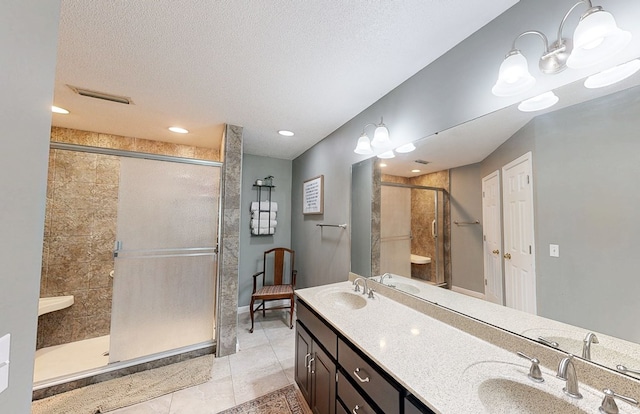 119 Willow Oaks Dr, Headland, AL 36345 - full bathroom featuring a sink, tile patterned flooring, double vanity, and a shower stall