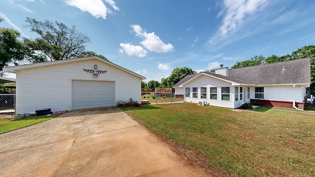 119 Willow Oaks Dr, Headland, AL 36345 - exterior space featuring a garage, an outbuilding, a chimney, a yard, and driveway