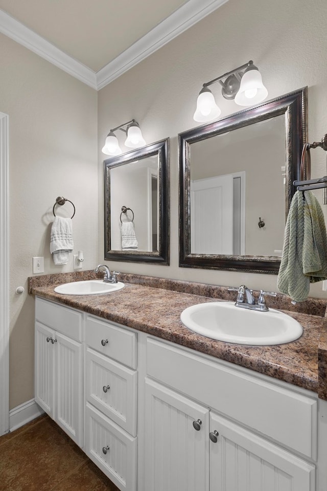 bathroom featuring double vanity, ornamental molding, and a sink