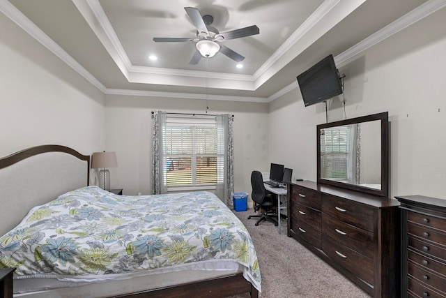 bedroom with light carpet, a raised ceiling, a ceiling fan, and crown molding