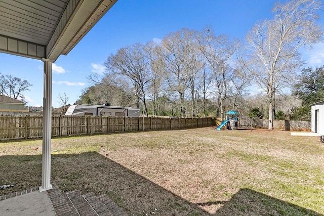 view of yard featuring a playground and a fenced backyard