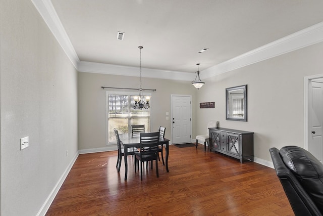 dining space featuring ornamental molding, dark wood-type flooring, visible vents, and baseboards