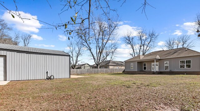 view of yard with an outdoor structure and fence