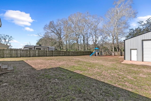 view of yard featuring a playground and a fenced backyard