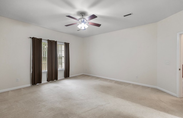 carpeted spare room with ceiling fan