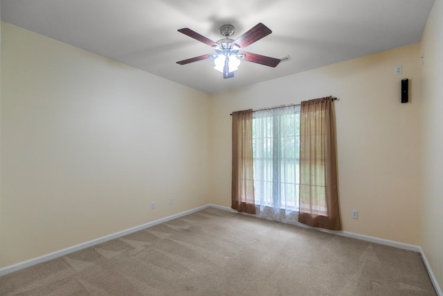 carpeted spare room featuring ceiling fan