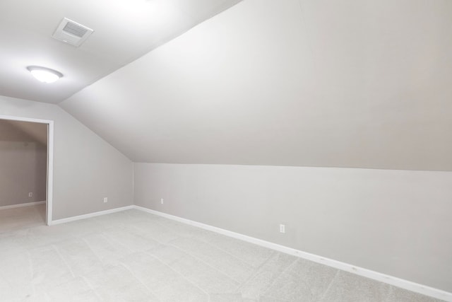 bonus room featuring light colored carpet and vaulted ceiling