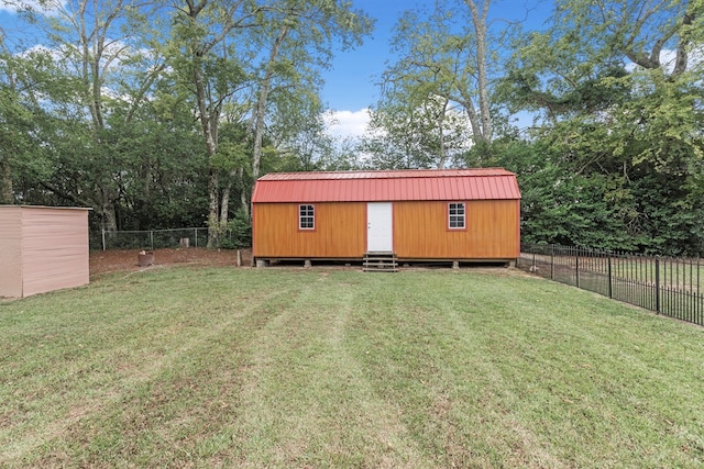 view of outbuilding with a yard