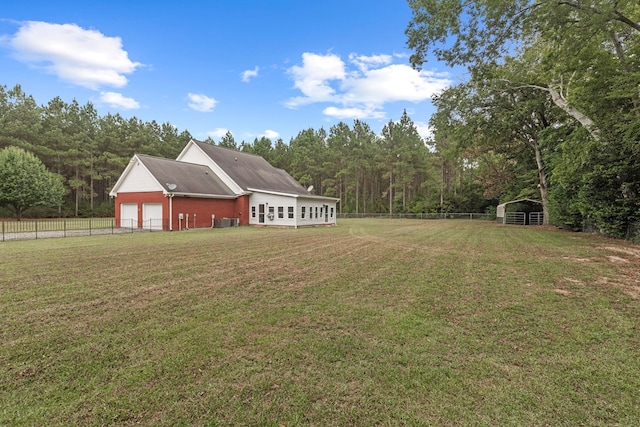 view of yard featuring central AC and an outdoor structure