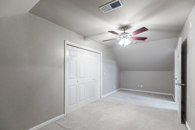 bonus room featuring light carpet, ceiling fan, and vaulted ceiling