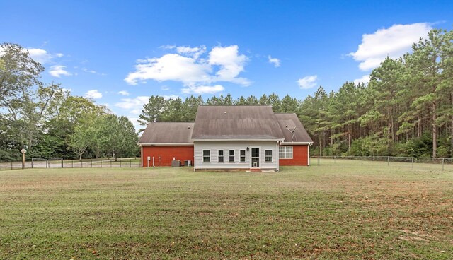 rear view of property with a yard