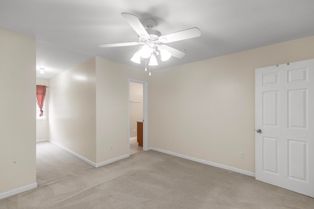 spare room featuring ceiling fan and light colored carpet