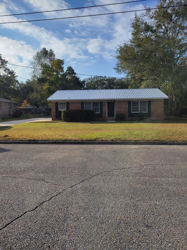 ranch-style home with a front lawn