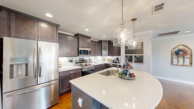 160 Sandbed Rd, Newton, AL 36352 - kitchen featuring stainless steel appliances, crown molding, dark brown cabinetry, dark wood-style floors, and a kitchen island with sink