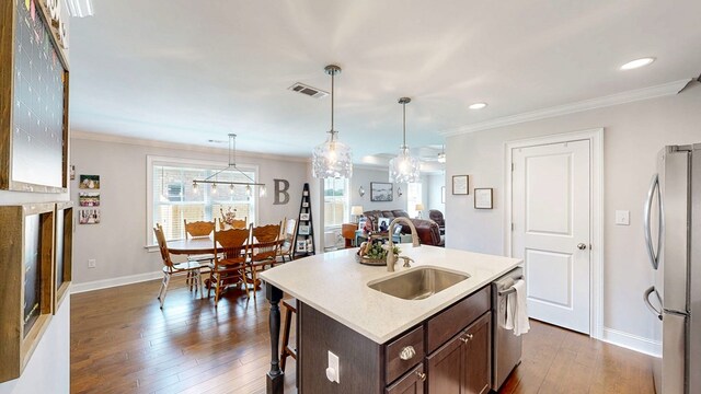 160 Sandbed Rd, Newton, AL 36352 - kitchen with appliances with stainless steel finishes, ornamental molding, dark wood-style floors, light countertops, and dark brown cabinetry