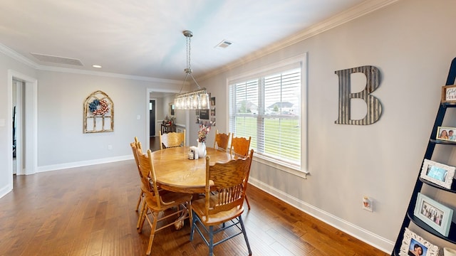 160 Sandbed Rd, Newton, AL 36352 - dining area with crown molding, dark wood-type flooring, and a chandelier