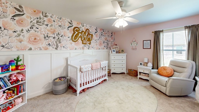 160 Sandbed Rd, Newton, AL 36352 - carpeted bedroom featuring a nursery area, a ceiling fan, wallpapered walls, and wainscoting