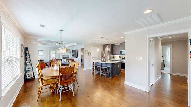 160 Sandbed Rd, Newton, AL 36352 - dining area featuring dark wood-type flooring, recessed lighting, a fireplace, and crown molding