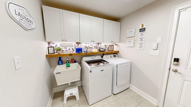 160 Sandbed Rd, Newton, AL 36352 - laundry area with washing machine and clothes dryer, cabinet space, and light tile patterned floors