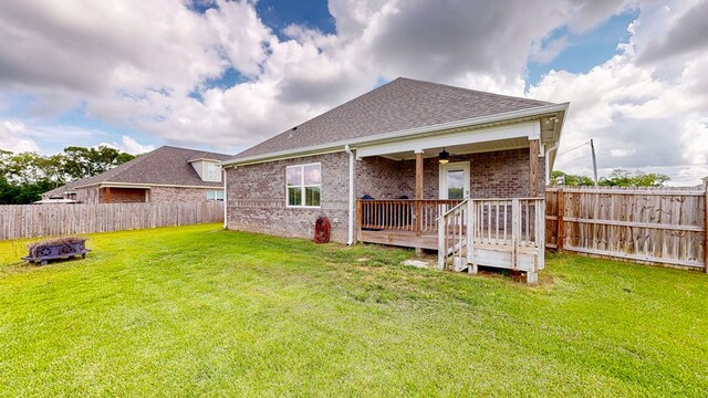 160 Sandbed Rd, Newton, AL 36352 - back of house with a fenced backyard, roof with shingles, brick siding, and an outdoor fire pit