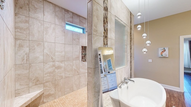 bathroom featuring shower with separate bathtub