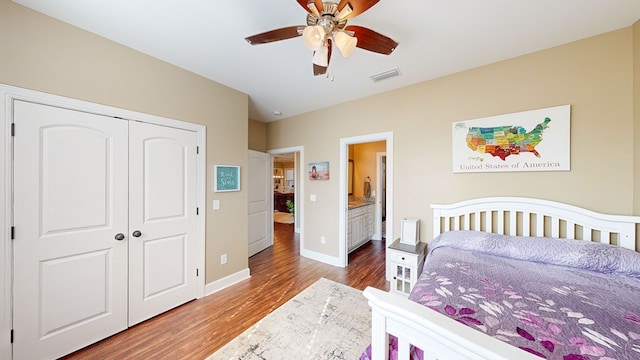 bedroom with hardwood / wood-style flooring, ceiling fan, and a closet