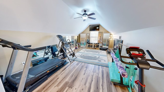 workout room featuring ceiling fan, lofted ceiling, and light wood-type flooring