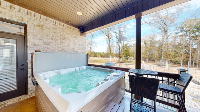 view of patio / terrace with a hot tub