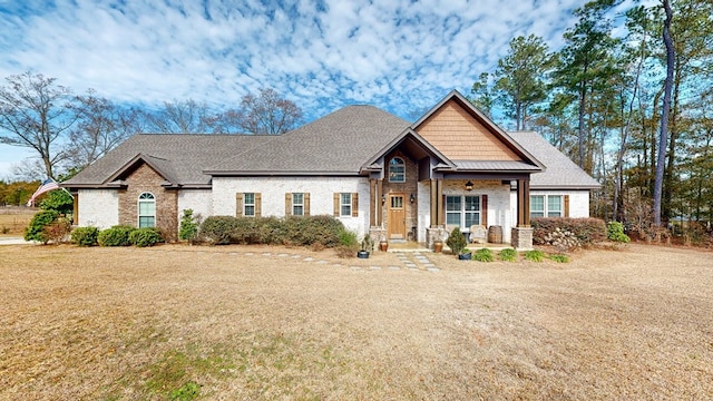 craftsman inspired home featuring a porch and a front yard